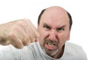 A middle age man yelling and hitting in an argument.  Anger Managment???